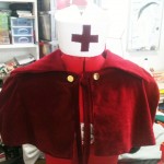 Red nurse cape and cap
