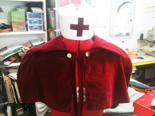 Red nurse cape and cap